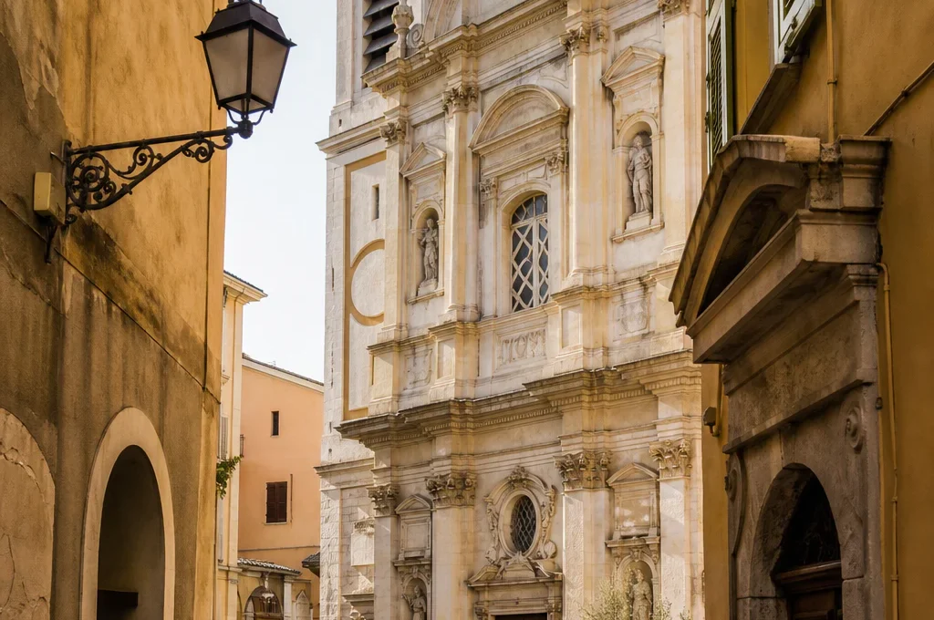 Baroque church facade in the narrow historic streets of Vieux-Nice under warm Mediterranean light.